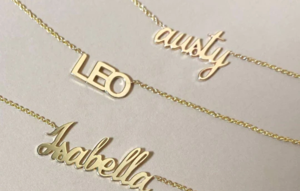 Three 14K solid gold name necklaces in different script fonts and block letter fonts.