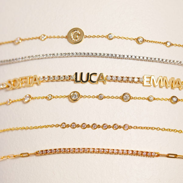14K solid gold and natural diamond jewelry with personalized names, tennis bracelets, and diamond strands.