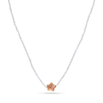A strand necklace of micro white pearls with purple star shaped pearl.