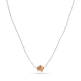 A strand necklace of micro white pearls with purple star shaped pearl.