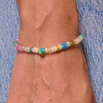 Model's wrist with multicolor bracelet with genuine opal and 14k solid gold beads.