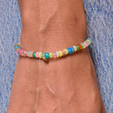 Model's wrist with multicolor bracelet with genuine opal and 14k solid gold beads.