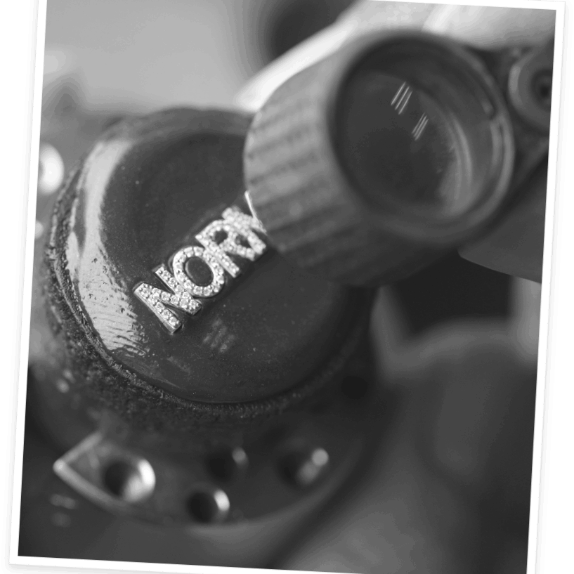 A photo of a 14K custom name with pave diamonds carefully set on the letters.