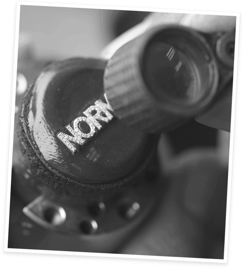 A photo of a 14K custom name with pave diamonds carefully set on the letters.
