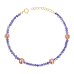 Gemstone and 14K gold bracelet with genuine tanzanite and station pink freshwater pearls. Includes solid gold spring lock and extender.