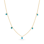 A 14k solid gold chain with 5 dainty turquoise beads draping off of it.