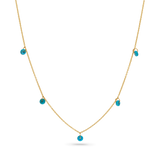 A 14k solid gold chain with 5 dainty turquoise beads draping off of it.