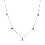 A 14k solid white gold chain with 5 dainty turquoise beads draping off of it.