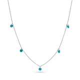 A 14k solid white gold chain with 5 dainty turquoise beads draping off of it.