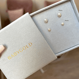 One pair of 6mm pearl stud earrings and one pair of 4mm pearl stud earrings in blue jewelry box.